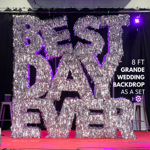 Decorative backdrop with 'BEST DAY EVER' text for a wedding, featuring large metallic letters.