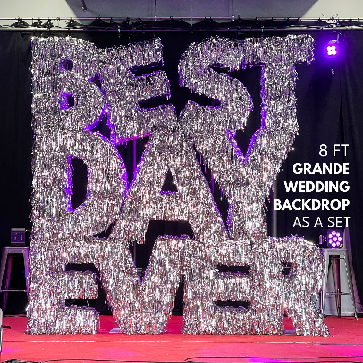 Decorative backdrop with 'BEST DAY EVER' text for a wedding, featuring large metallic letters.